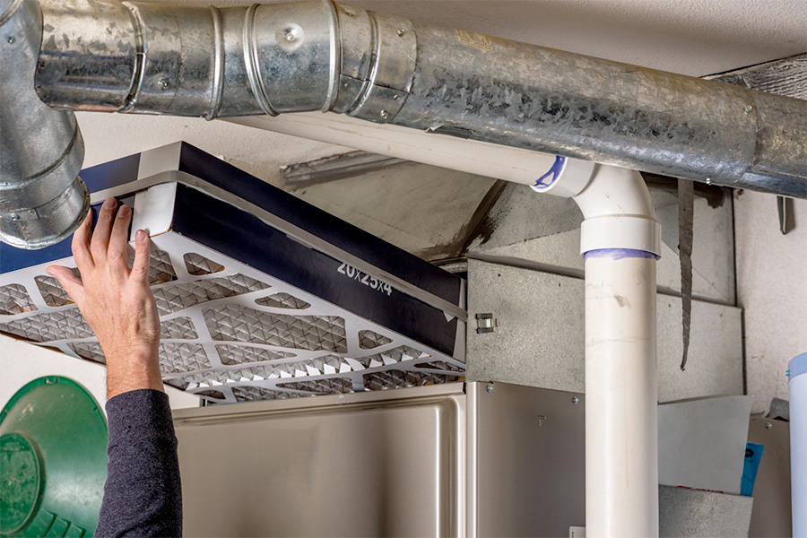 man performing furnace maintenance