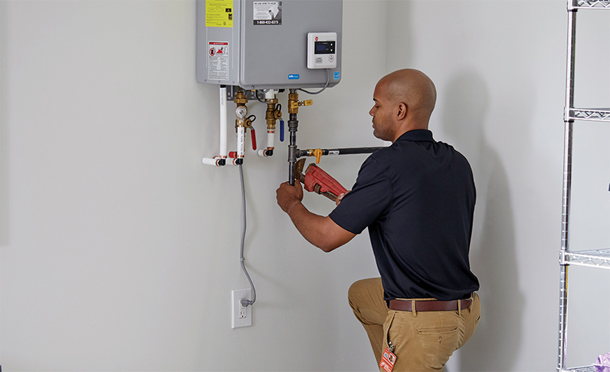 man installing a tankless water heater