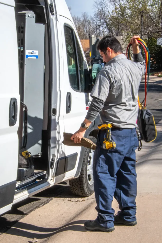 Technician preparing HVAC equipment from service van