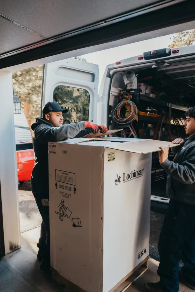 Workers loading equipment into a van for transportation