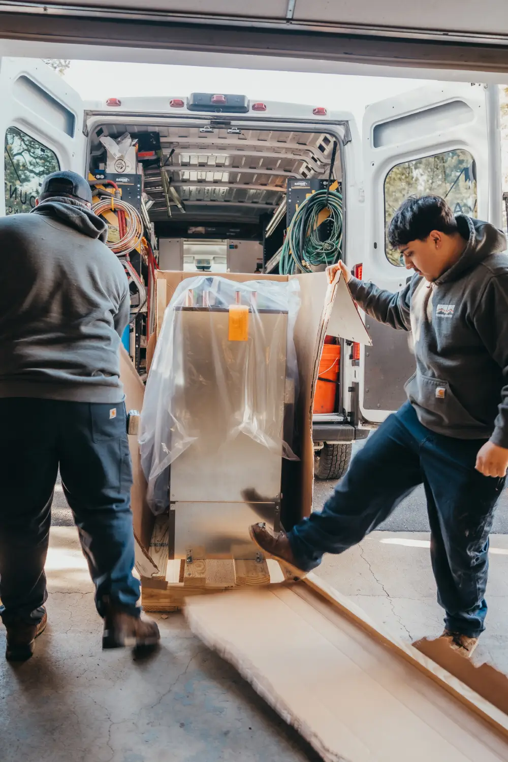 Workers loading furniture into a delivery van for moving services