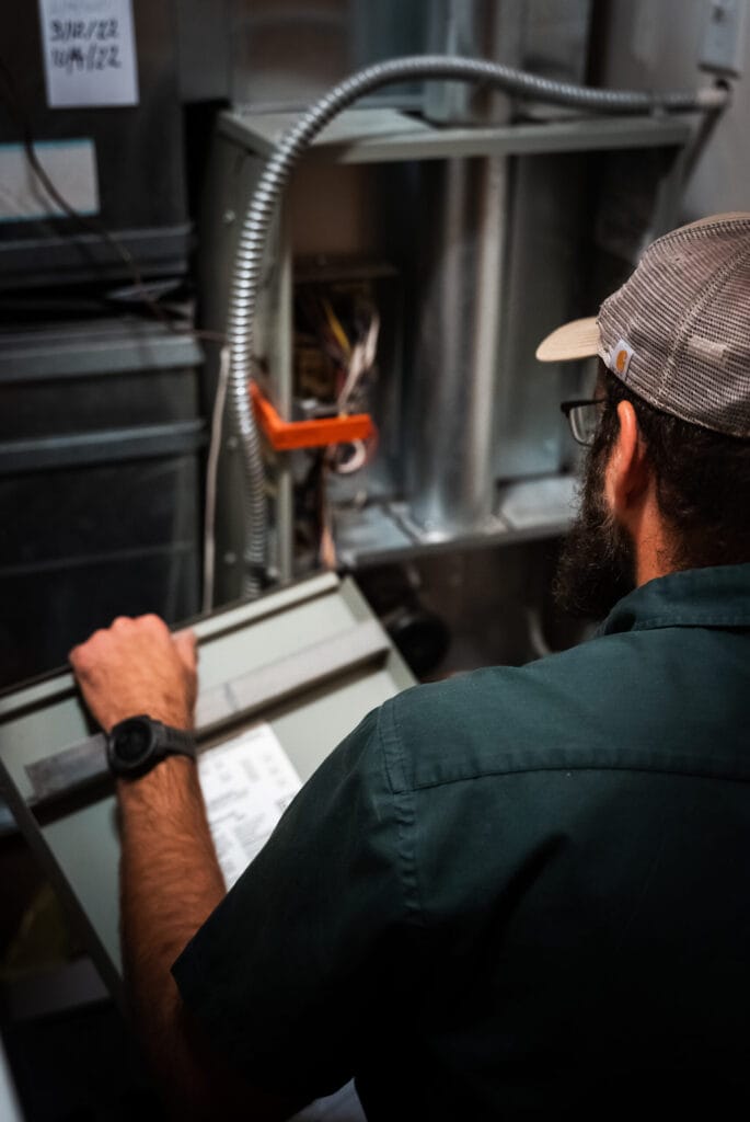 Mountain Valley Plumbing, Heating and Cooling technician performing HVAC service in Colorado.